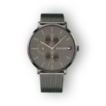 Gray Tommy Hilfiger watch with dual sub-dials and silver mesh bracelet, showcasing a sleek, modern design against a black background.