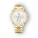 Gold-toned Tommy Hilfiger watch with a white textured dial, featuring date and chronograph subdials, on a matching bracelet.