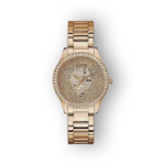 Arany színű Guess óra, díszes számlappal és kristályokkal keretezve.