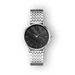 Silver-toned watch with a black textured dial and minimalist indices, featuring a woven stainless steel bracelet, set against a black background.